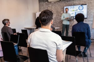 rear-view-of-man-at-business-presentation-2026-03-18-15-04-46-utc